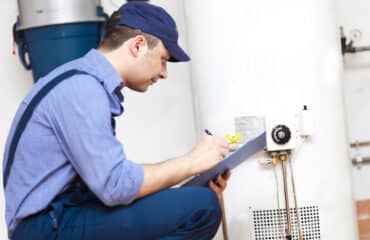Accurate plumber evaluating water heater
