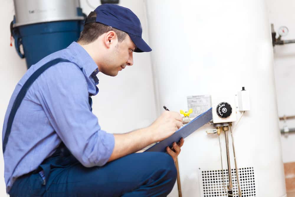 Accurate plumber evaluating water heater